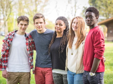 A diverse group of people with their arms around each other.