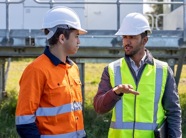 2 construction workers having a conversation.