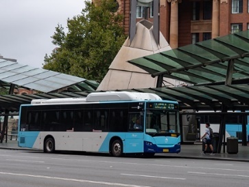 A bus arriving at a bus stop.
