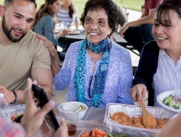 A group of people having a conversation at an event in a public space.