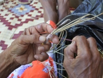 An Aboriginal person practicing a cultural activity.